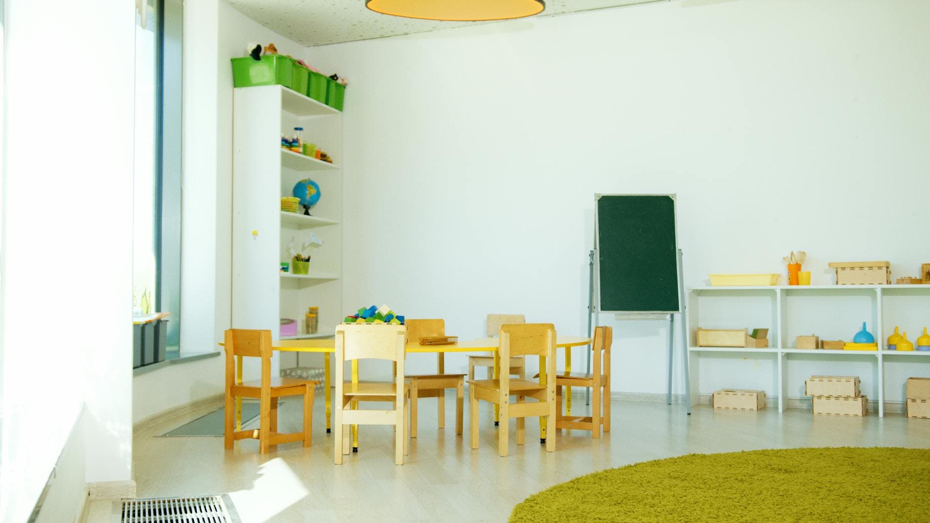 Bright cheerful preschool classroom with toys and books